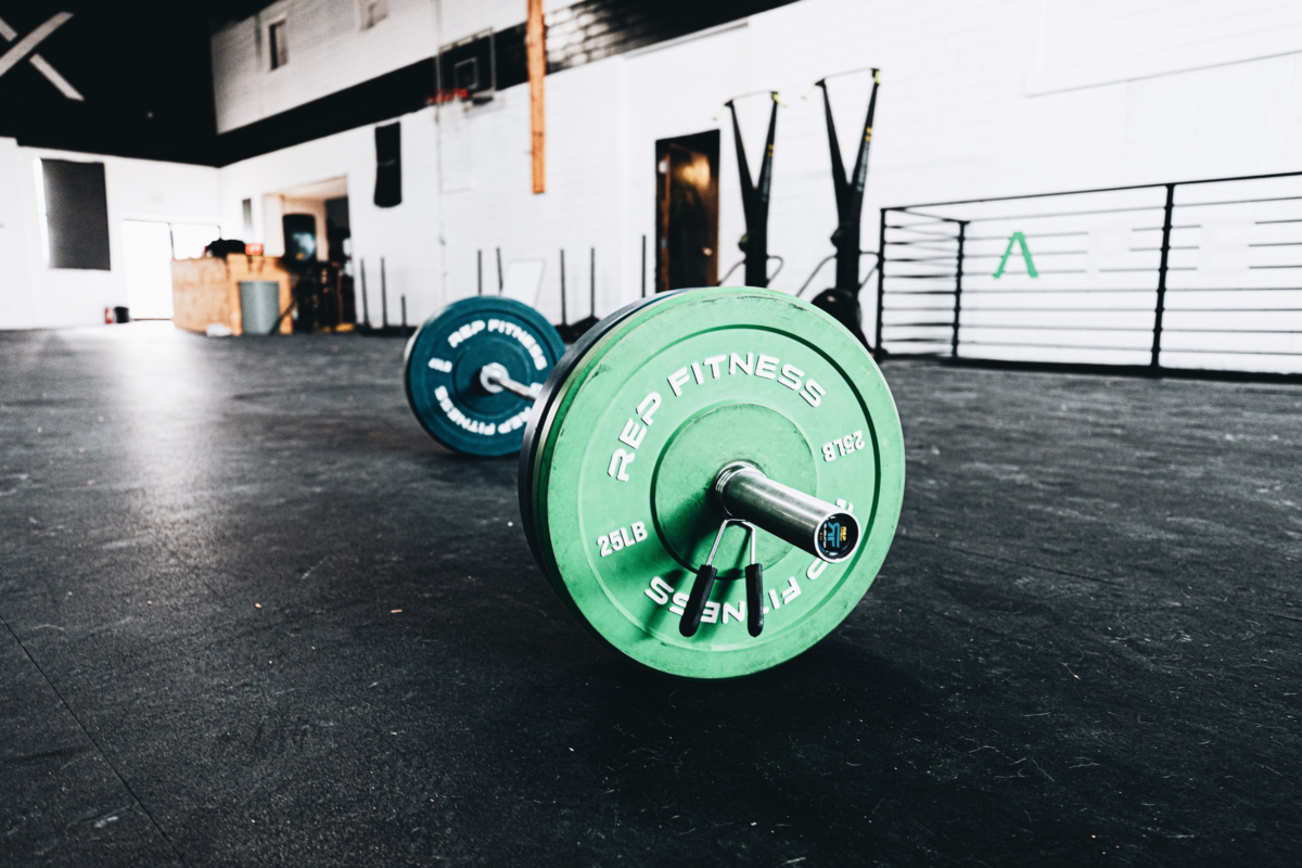 barbell with weights on the ground