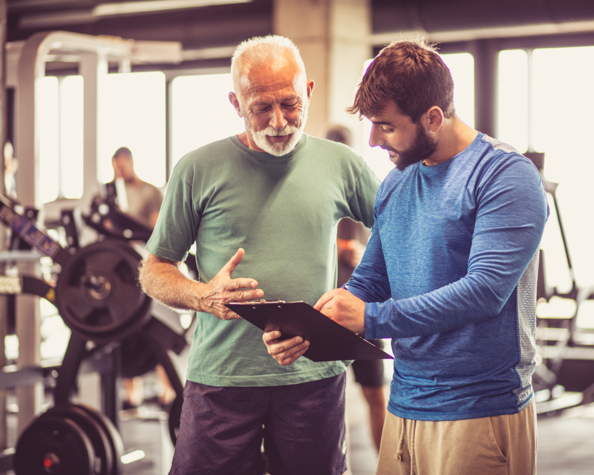 Trainer describing exercise plan to a client