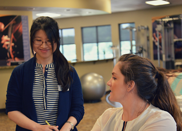 Intern, Yinghua Zhang, learning about patient care from Clinic Director Erin Golden, DPT, at the Acworth East Clinic.